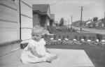 Anne Delong on front porch 254 Caddy St 1950 looking east